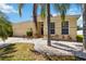 A charming house with a well-kept yard featuring palm trees, plants, and a clean driveway at 6838 44Th E Ter, Bradenton, FL 34203