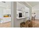 Modern kitchen with white cabinets, light countertops, stainless steel appliances, and pass-through bar at 6838 44Th E Ter, Bradenton, FL 34203