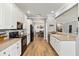Well-lit kitchen with stainless steel appliances, white cabinets, and modern finishes, ready for culinary adventures at 6838 44Th E Ter, Bradenton, FL 34203