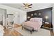 Inviting primary bedroom featuring a comfortable bed, accent wall, and elegant decor, designed for relaxation at 6838 44Th E Ter, Bradenton, FL 34203