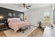 Tranquil primary bedroom with a plush bed, accent wall, and natural light, creating a serene retreat at 6838 44Th E Ter, Bradenton, FL 34203