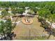 Aerial photograph of a playground featuring a slide and swings in a fenced, grassy park area at 6838 44Th E Ter, Bradenton, FL 34203