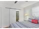 Bedroom featuring a barn door leading to the bathroom, bedside tables, and striped bedding at 7114 11Th W Ave, Bradenton, FL 34209