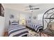 Cozy bedroom with two twin beds, ceiling fan, and nautical decor at 7114 11Th W Ave, Bradenton, FL 34209