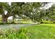Community shuffleboard courts surrounded by mature trees and greenery at 7114 11Th W Ave, Bradenton, FL 34209