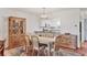 Dining room with wooden table and chairs, china cabinet, and view of the kitchen at 7114 11Th W Ave, Bradenton, FL 34209