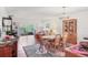 Dining room adjacent to the living room features a wooden table and chairs and large windows at 7114 11Th W Ave, Bradenton, FL 34209