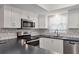 Bright kitchen features stainless steel appliances, white cabinets, and dark countertops at 7114 11Th W Ave, Bradenton, FL 34209