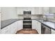 Bright kitchen with stainless steel appliances, white cabinetry, and tile backsplash at 7114 11Th W Ave, Bradenton, FL 34209