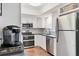 Bright kitchen with stainless steel appliances, white cabinetry, and tile backsplash at 7114 11Th W Ave, Bradenton, FL 34209