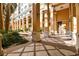 Beautiful courtyard with decorative tile work and large pillars, creating a serene outdoor space at 750 N Tamiami Trl # 1203, Sarasota, FL 34236