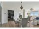 Dining area with chandelier with kitchen and living room in the background and views of the ocean at 750 N Tamiami Trl # 1203, Sarasota, FL 34236