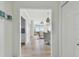 Bright entryway with views into a dining area featuring wood flooring and an elegant chandelier at 750 N Tamiami Trl # 1203, Sarasota, FL 34236