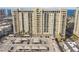 Large multi-story condominium building with a parking structure in front at 750 N Tamiami Trl # 1203, Sarasota, FL 34236