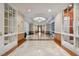 Long hallway with patterned tile floors, neutral paint, and several entrance doors at 750 N Tamiami Trl # 1203, Sarasota, FL 34236