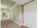 Well-lit hallway with elegant wallpaper, decorative carpeting, and neutral tones at 750 N Tamiami Trl # 1203, Sarasota, FL 34236