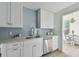 Bright kitchen with stainless steel appliances, light countertops, and light blue tile backsplash at 750 N Tamiami Trl # 1203, Sarasota, FL 34236