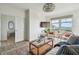 Bright living room featuring waterfront views, modern decor, and comfortable seating at 750 N Tamiami Trl # 1203, Sarasota, FL 34236