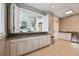 A well-appointed lobby with a view to the main area, a granite countertop, and light tile floors at 750 N Tamiami Trl # 1203, Sarasota, FL 34236