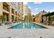 Sparkling outdoor swimming pool with ample lounge seating and lush landscaping at 750 N Tamiami Trl # 1203, Sarasota, FL 34236