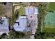 Aerial view of a property featuring a main house, guest house, tennis court and beautifully landscaped yard at 763 Siesta Dr, Sarasota, FL 34242
