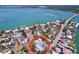 Aerial view of a home with waterfront access, nestled among luxury homes with lush landscaping at 763 Siesta Dr, Sarasota, FL 34242