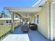 Cozy covered back patio featuring comfortable seating and view of the backyard at 763 Siesta Dr, Sarasota, FL 34242