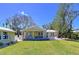 Well-maintained home with green lawn, a detached garage, and nice landscaping at 763 Siesta Dr, Sarasota, FL 34242