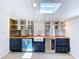 Home bar with wood countertop, stainless shelving, wine fridge, and white shiplap at 763 Siesta Dr, Sarasota, FL 34242