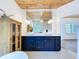 Bathroom featuring double sinks and dark vanity with wood ceiling at 763 Siesta Dr, Sarasota, FL 34242