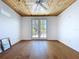 Bedroom showcasing hardwood floors, wood paneled ceiling, and access to a private balcony at 763 Siesta Dr, Sarasota, FL 34242