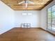 Bright bedroom features hardwood floors, a wood paneled ceiling, and access to outdoors at 763 Siesta Dr, Sarasota, FL 34242