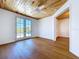 Bedroom with wood ceiling, hardwood floors, and French doors to outdoor deck at 763 Siesta Dr, Sarasota, FL 34242