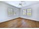 This bright bedroom offers wood floors and great natural light from the two windows at 763 Siesta Dr, Sarasota, FL 34242