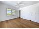 Bright bedroom features white walls, wood floors, and a window with a view at 763 Siesta Dr, Sarasota, FL 34242