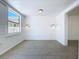 Bright bedroom with shiplap walls, sconce lighting, and large window overlooking the yard at 763 Siesta Dr, Sarasota, FL 34242