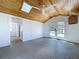 Bright bonus room with wood ceiling and fan, shiplap walls, French doors, and a skylight at 763 Siesta Dr, Sarasota, FL 34242