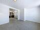Bright bonus room with shiplap walls, epoxy floors, and views to another room at 763 Siesta Dr, Sarasota, FL 34242