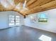 Bright bonus room with wood ceiling, ceiling fan, shiplap walls, and French doors at 763 Siesta Dr, Sarasota, FL 34242