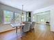 A dining room with hardwood floors, three windows, and table with seating for four at 763 Siesta Dr, Sarasota, FL 34242