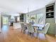 A dining room features a table with seating, three windows and light green built-in shelves at 763 Siesta Dr, Sarasota, FL 34242