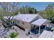 Inviting yellow home with a metal roof, a cozy porch and white picket fence for enhanced curb appeal at 763 Siesta Dr, Sarasota, FL 34242