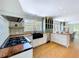 Bright kitchen with stainless steel appliances, farmhouse sink, butcher block countertops and patterned tile at 763 Siesta Dr, Sarasota, FL 34242