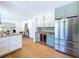 Kitchen featuring stainless steel refrigerator, wine storage, and light green cabinets at 763 Siesta Dr, Sarasota, FL 34242