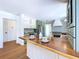 Kitchen island with wood countertop in a bright kitchen with tile backsplash at 763 Siesta Dr, Sarasota, FL 34242