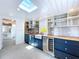 Bright kitchen features custom cabinets, wood countertops, stainless steel backsplash and appliances, and a skylight at 763 Siesta Dr, Sarasota, FL 34242