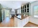 The kitchen features stainless steel appliances, white and light green cabinets, and a tile backsplash at 763 Siesta Dr, Sarasota, FL 34242