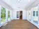 Sun room with wood floors and abundance of light, features view of the patio and yard at 763 Siesta Dr, Sarasota, FL 34242