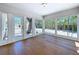 Sun room features wood floors and floor to ceiling windows offering plenty of natural light and views of the yard at 763 Siesta Dr, Sarasota, FL 34242