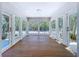 The sun room with wood floors has an abundance of natural light and views of the outdoors at 763 Siesta Dr, Sarasota, FL 34242